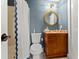 Cozy bathroom with a nautical theme with granite counters and tub with a shower at 898 Baybreeze Way # 880, New Smyrna Beach, FL 32169