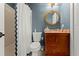 Comfortable bathroom displays a nautical theme with granite counters and tub with a shower at 898 Baybreeze Way # 880, New Smyrna Beach, FL 32169