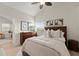 Bright bedroom boasts a large window, wood-look floors, and tasteful decor at 898 Baybreeze Way # 880, New Smyrna Beach, FL 32169