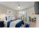 Comfortable bedroom featuring coastal decor, a blue bedspread, and an adjoining dining area, perfect for a relaxing getaway at 898 Baybreeze Way # 880, New Smyrna Beach, FL 32169