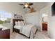 Cozy bedroom features wood-look floors, a ceiling fan and a decorative nautical theme at 898 Baybreeze Way # 880, New Smyrna Beach, FL 32169