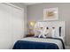 Cozy bedroom featuring blue bedding, closet, and coastal decor for a relaxing and stylish retreat at 898 Baybreeze Way # 880, New Smyrna Beach, FL 32169