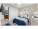 Charming bedroom with blue bedding, and an en-suite bathroom featuring a vanity and toilet, creating a cozy retreat at 898 Baybreeze Way # 880, New Smyrna Beach, FL 32169