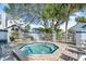 Outdoor hot tub surrounded by lounge chairs and lush greenery at 898 Baybreeze Way # 880, New Smyrna Beach, FL 32169