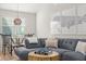 Inviting living room featuring a gray sectional sofa, dining area, and coastal-themed décor for a cozy and stylish space at 898 Baybreeze Way # 880, New Smyrna Beach, FL 32169