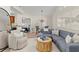 Bright living room featuring a gray sectional, wood coffee table, and dining area with an open view to the bedroom at 898 Baybreeze Way # 880, New Smyrna Beach, FL 32169