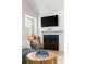 Cozy living room featuring a fireplace, large screen TV, and a gray sectional, creating a comfortable and inviting space at 898 Baybreeze Way # 880, New Smyrna Beach, FL 32169