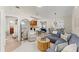 Spacious living space featuring modern furnishings, light wood floors, and vaulted ceilings at 898 Baybreeze Way # 880, New Smyrna Beach, FL 32169