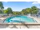 Community pool with sun loungers under a blue sky at 898 Baybreeze Way # 880, New Smyrna Beach, FL 32169