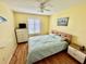 Inviting bedroom with yellow walls, wood headboard, and a ceiling fan for added comfort at 112 Lagoon Ct, New Smyrna Beach, FL 32169