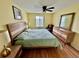 Comfortable bedroom with light yellow walls, ceiling fan, and wood-accented furniture at 112 Lagoon Ct, New Smyrna Beach, FL 32169