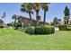 Well-maintained brick exterior with lush landscaping and mature palm trees at 112 Lagoon Ct, New Smyrna Beach, FL 32169