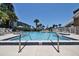 Community pool with clear blue water and surrounding lounge chairs for relaxation at 112 Lagoon Ct, New Smyrna Beach, FL 32169