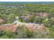Aerial view of community townhomes, lush landscape, and tree-lined streets at 210 Pine Cone Trl, Ormond Beach, FL 32174