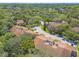 An aerial perspective of townhomes within a serene neighborhood with tree coverage at 210 Pine Cone Trl, Ormond Beach, FL 32174