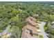 Townhomes pictured in an aerial view, nestled among a landscape of trees at 210 Pine Cone Trl, Ormond Beach, FL 32174