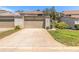 Townhome featuring an attached garage and quaint landscaping at 210 Pine Cone Trl, Ormond Beach, FL 32174