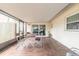 Enclosed porch with tile floors, table and chairs, and sliding glass doors at 222 Brittany Ave, Port Orange, FL 32127