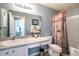 Inviting bathroom featuring a shower, sink with vanity, toilet, and decorative shower curtain at 2689 Sicily Dr, New Smyrna Beach, FL 32168