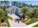 Stunning home featuring a tiled driveway, manicured landscaping, and a vibrant blue double-door entrance at 3045 Borassus Dr, New Smyrna Beach, FL 32168