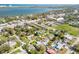 Aerial view of a neighborhood with single-Gathering homes near a body of water and cityscape in the distance at 312 Jefferson Ave, Port Orange, FL 32127