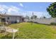 Grassy backyard offering a shed, white privacy fence, and mature trees at 312 Jefferson Ave, Port Orange, FL 32127