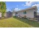 Backyard view with storage shed and manicured landscaping and room for gardening at 312 Jefferson Ave, Port Orange, FL 32127