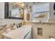 Detailed bathroom with white fixtures, decorative mirror, and mosaic tile accents at 312 Jefferson Ave, Port Orange, FL 32127