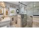 Elegant bathroom with marble countertop, decorative mirror, and glass shower enclosure at 312 Jefferson Ave, Port Orange, FL 32127