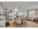 Bright dining area featuring white cabinets, wood flooring, and a modern light fixture at 312 Jefferson Ave, Port Orange, FL 32127