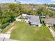 Charming single-story home with a spacious green lawn, white picket fence, and shed surrounded by lush trees at 312 Jefferson Ave, Port Orange, FL 32127