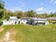Well-manicured lawn, fenced yard, shed and American flag add charm to this home's exterior at 312 Jefferson Ave, Port Orange, FL 32127