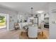 View of open kitchen and dining area with stainless steel appliances and backsplash at 312 Jefferson Ave, Port Orange, FL 32127