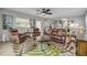 Living room with ample seating, a ceiling fan, and lots of natural light at 312 Jefferson Ave, Port Orange, FL 32127