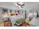 Spacious main bedroom with white furniture, ceiling fan, and colorful accents at 312 Jefferson Ave, Port Orange, FL 32127