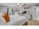 Comfortable main bedroom with ceiling fan, white furnishings and bright, sunny windows at 312 Jefferson Ave, Port Orange, FL 32127