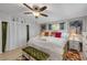 Well-lit main bedroom with white furnishings, colorful accents, and wood-look flooring at 312 Jefferson Ave, Port Orange, FL 32127