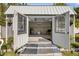 Open shed showing the interior including lights, fan, air conditioner, and seating at 312 Jefferson Ave, Port Orange, FL 32127