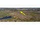 Sweeping aerial shot of an expansive lot, emphasized with a yellow arrow, displaying its prime location and scenery at 3890 Skyway Dr, Sanford, FL 32773