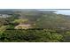 Aerial view of wooded real estate with a partial yellow boundary and a structure, near a marsh at 3890 Skyway Dr, Sanford, FL 32773