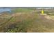 Breathtaking aerial view of a large lot, pinpointed by a bright yellow arrow, showcasing the lot's picturesque setting at 3890 Skyway Dr, Sanford, FL 32773