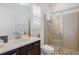 Modern bathroom with a glass-enclosed shower, vanity, and neutral tones at 465 White Cotton Cir, Oviedo, FL 32765