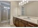 Bright bathroom with double vanity, granite countertop, wood cabinets, and glass shower at 465 White Cotton Cir, Oviedo, FL 32765