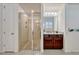 Bright bathroom featuring a glass shower, a vanity with granite countertop, and wood cabinets at 465 White Cotton Cir, Oviedo, FL 32765