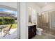 Bathroom with a glass-enclosed shower and vanity, with an outdoor view at 465 White Cotton Cir, Oviedo, FL 32765