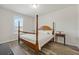 Bedroom features a classic wood four-poster bed, light wood floors, and bright natural light at 465 White Cotton Cir, Oviedo, FL 32765