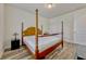 Bright bedroom with a four-poster bed, wooden floors, and closet access at 465 White Cotton Cir, Oviedo, FL 32765