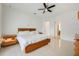 Bright bedroom featuring a wooden platform bed, ceiling fan, and tile flooring at 465 White Cotton Cir, Oviedo, FL 32765