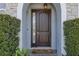 Close-up of the elegant front door with sidelight and modern hardware at 465 White Cotton Cir, Oviedo, FL 32765