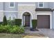 Charming front entrance with stone accents and well-maintained landscaping at 465 White Cotton Cir, Oviedo, FL 32765